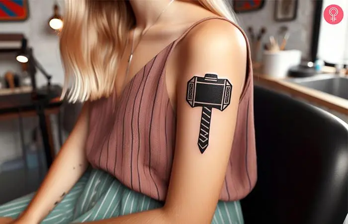 A traditional Mjolnir tattoo on a woman’s arm