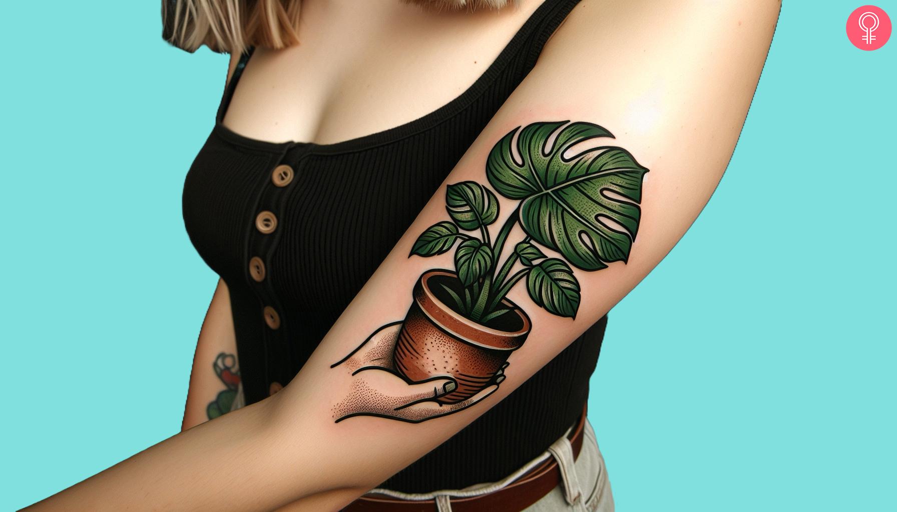 Traditional Monstera plant tattoo on a woman’s upper arm