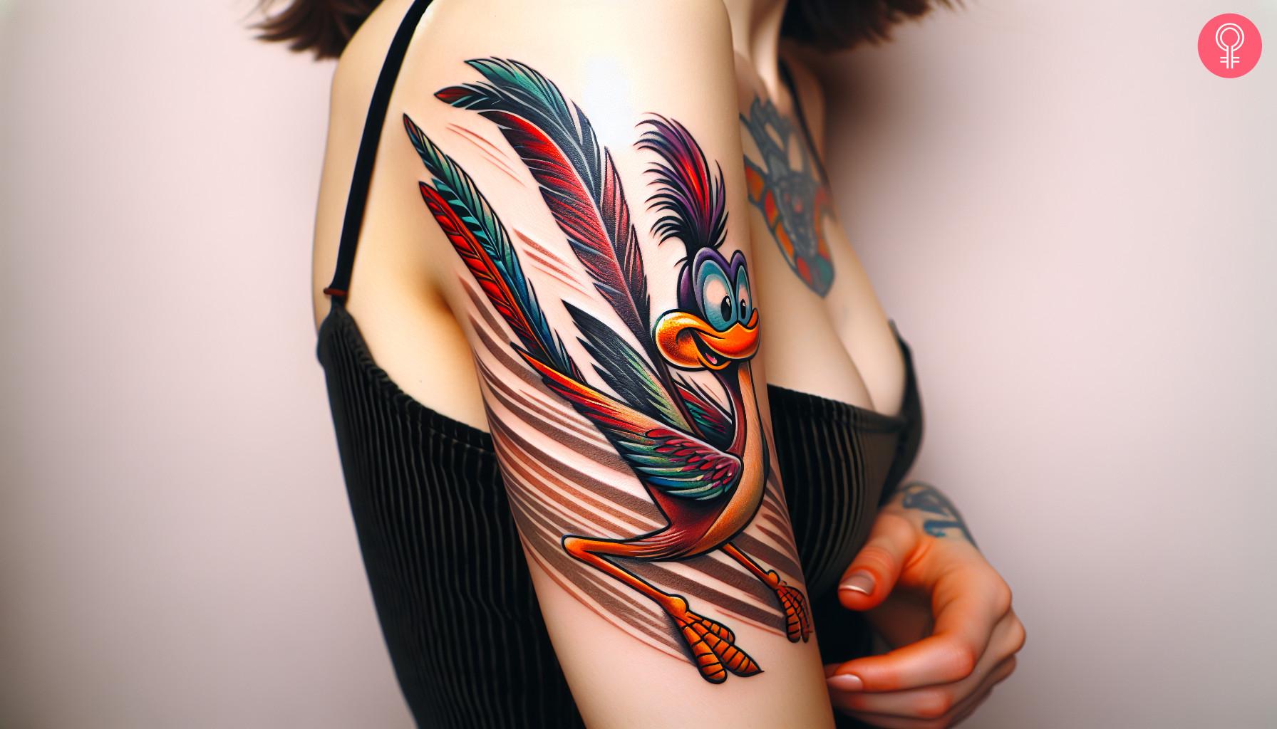 A woman wearing a traditional roadrunner tattoo on the upper arm.