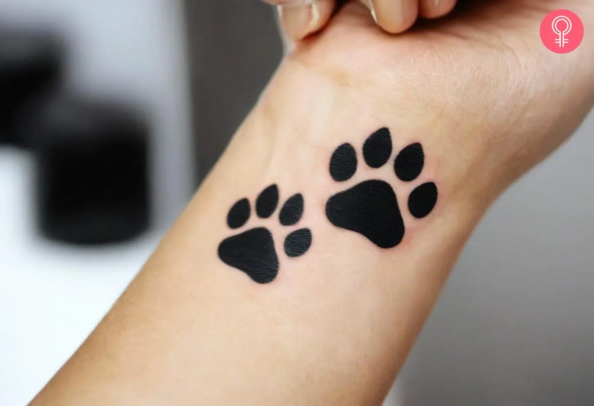 Traditional cat paw tattoo on her wrist