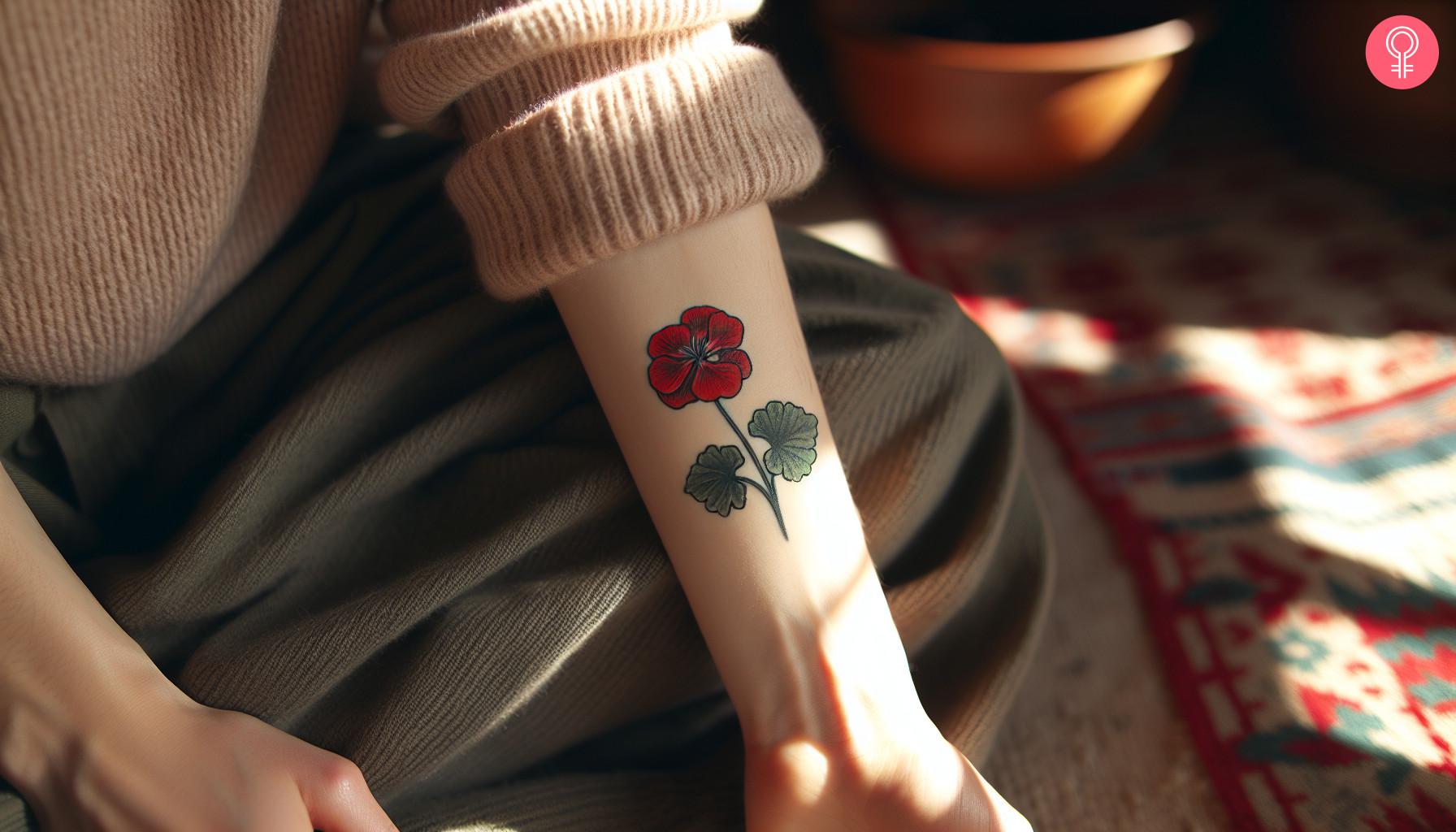 Traditional geranium tattoo on a woman's forearm