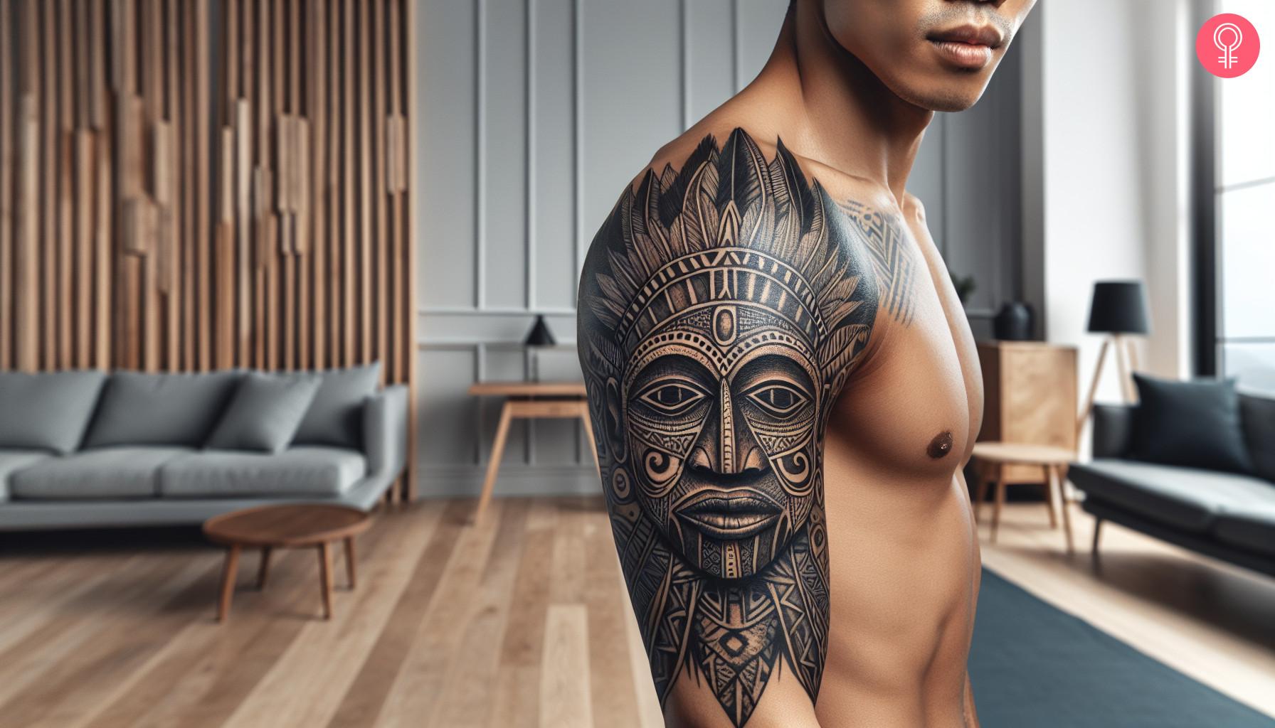 Tribal mask tattoo on upper arm