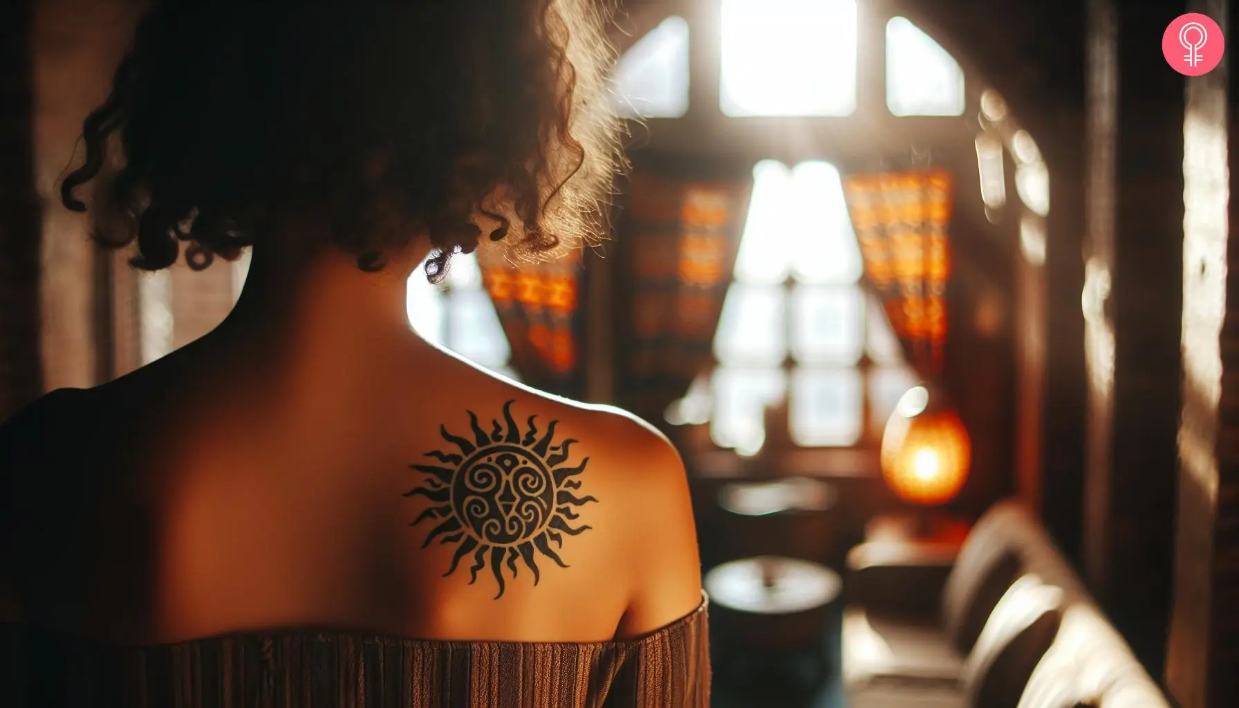 Tribal sun tattoo on the back shoulder