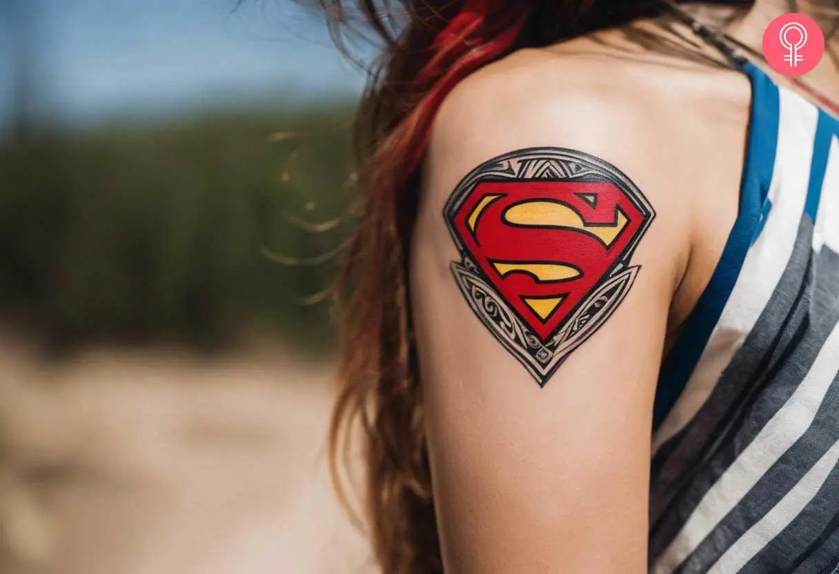 Tribal Superman tattoo on a woman’s arm