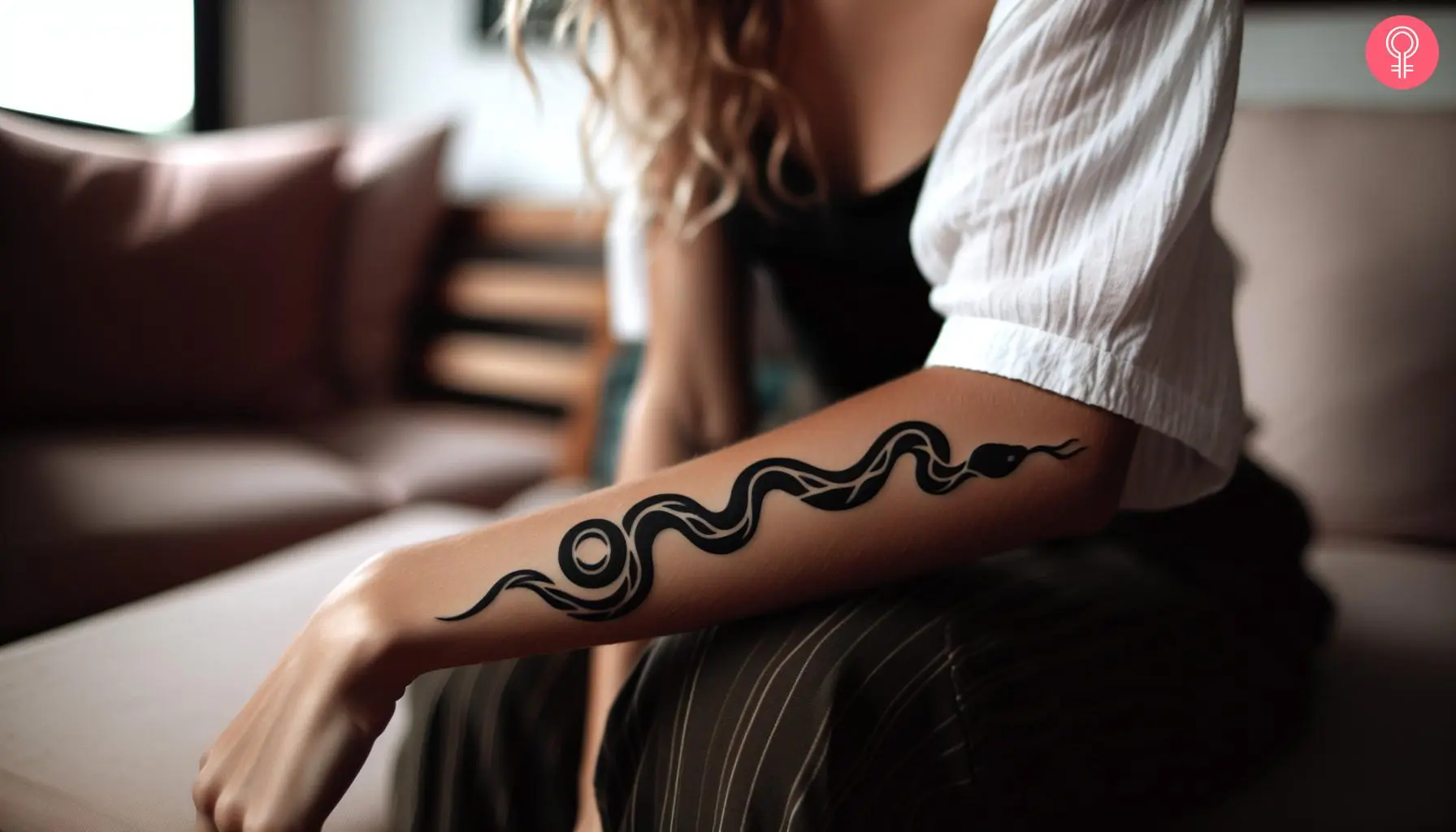 Tribal snake tattoo on the forearm of a woman