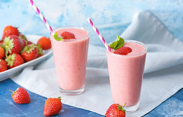 Two glasses of homemade soy milk and strawberry protein shake on the table