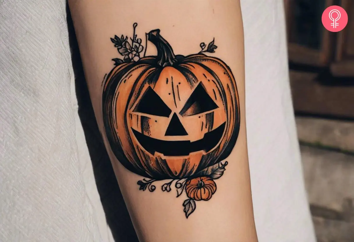 A vintage jack-o'-lantern tattoo on the forearm