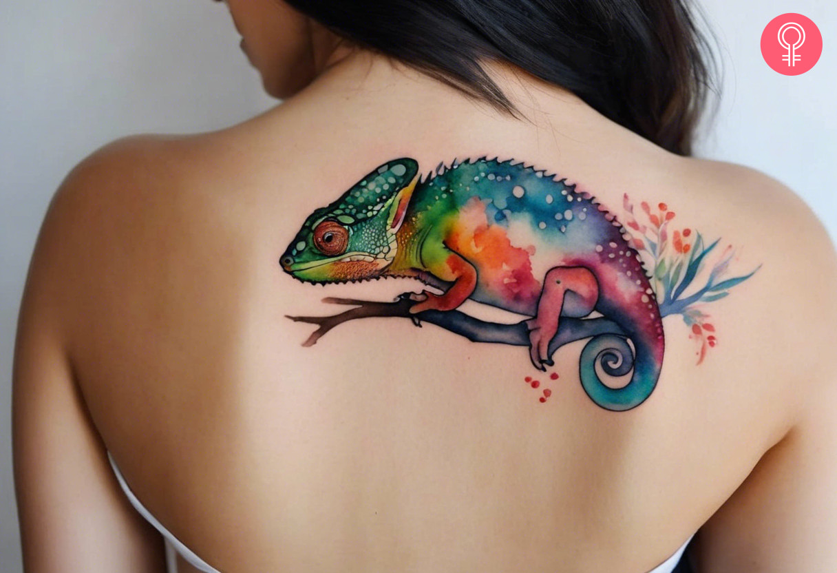 A watercolor chameleon tattoo on a woman’s back