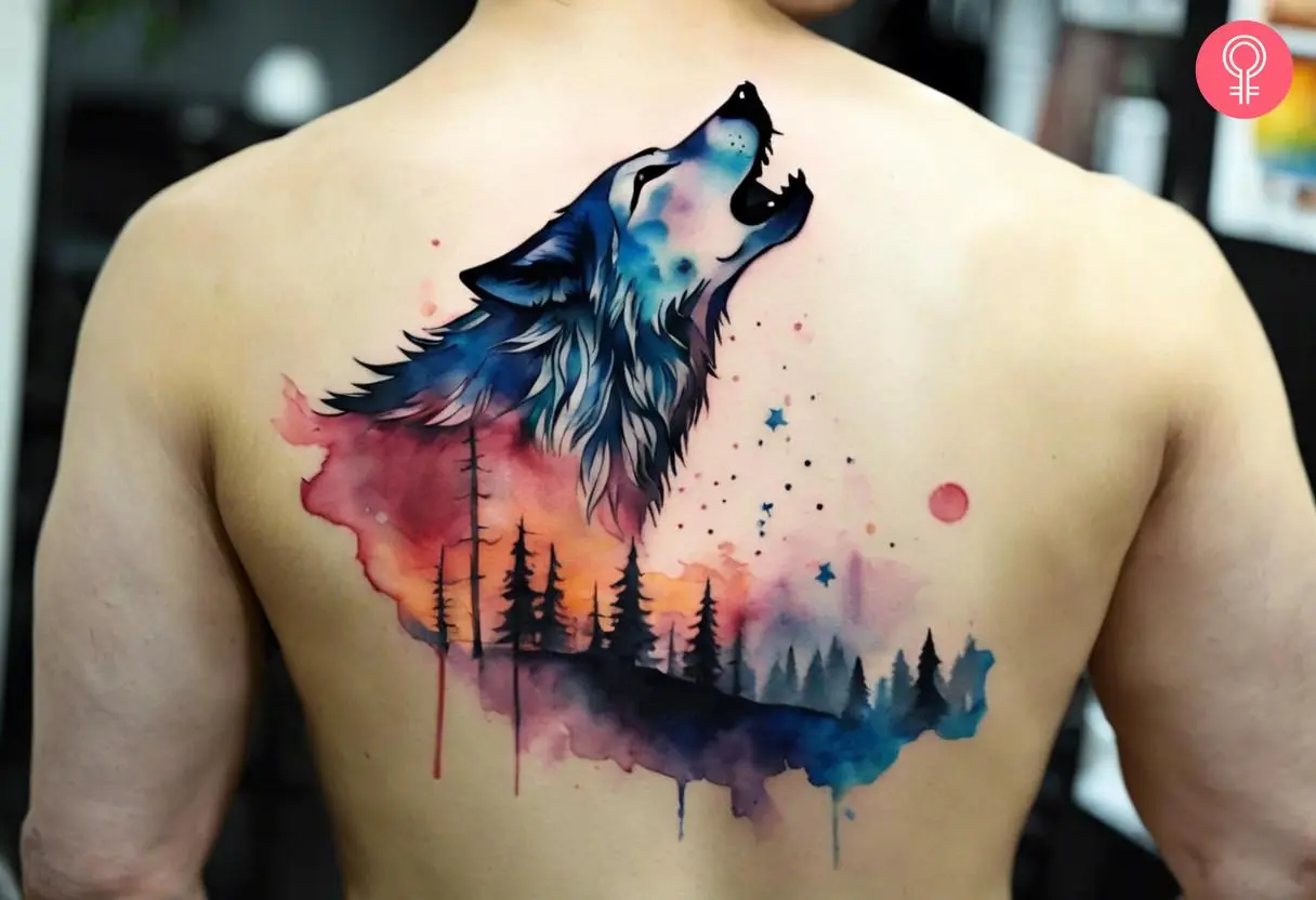 Watercolor howling wolf tattoo on the upper back of a man