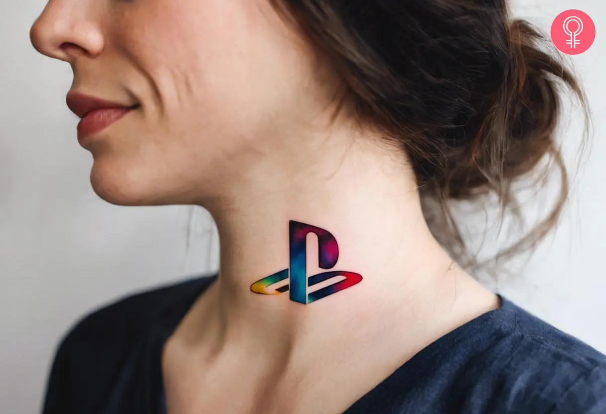 A watercolor PlayStation tattoo on a woman’s neck