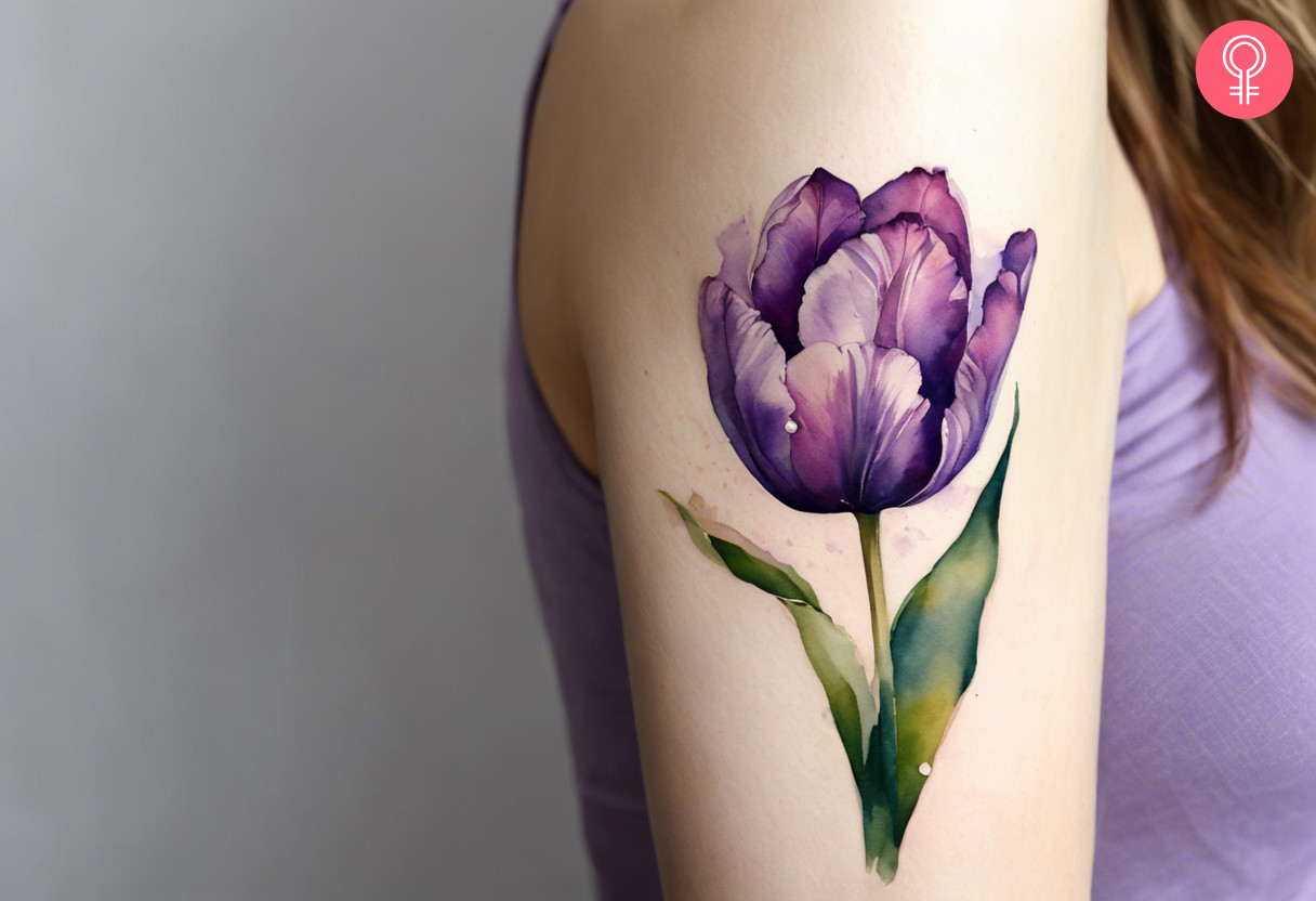 Watercolor purple flower tattoo on the arm of a woman