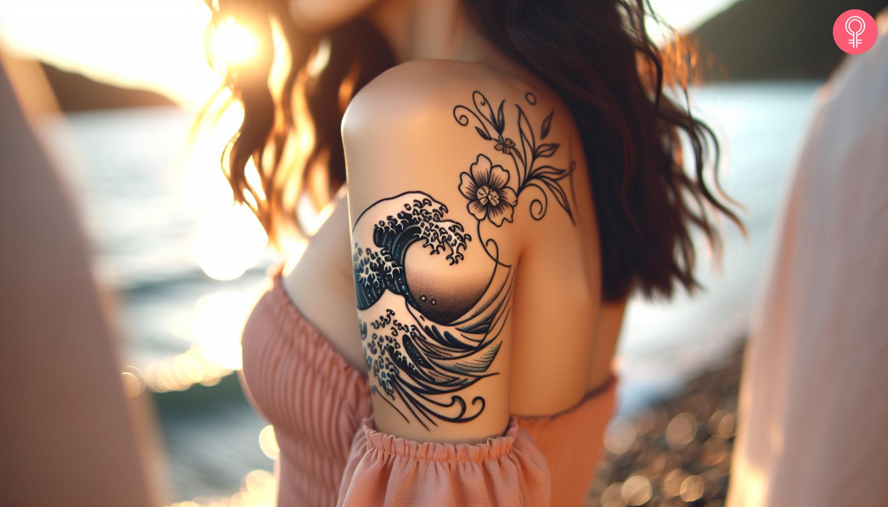 Wave and flower tattoo on the shoulder