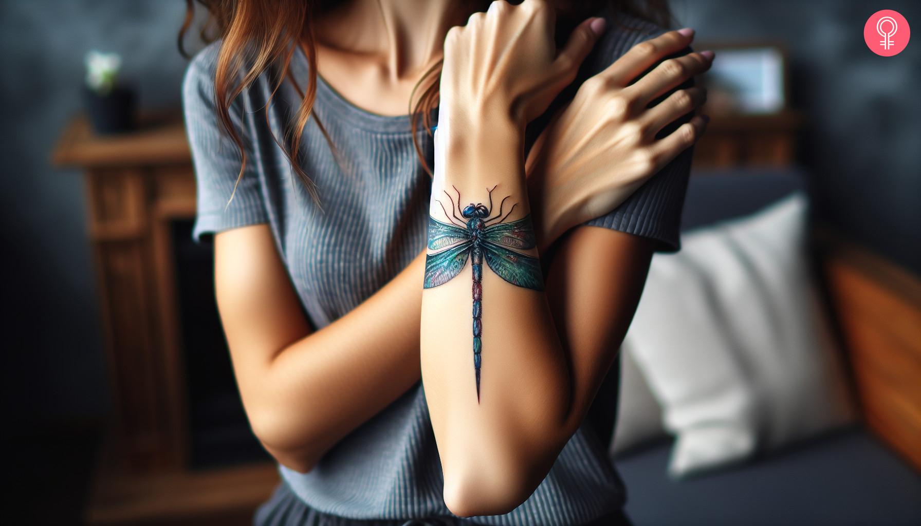 Playful dragonfly tattoo on forearm