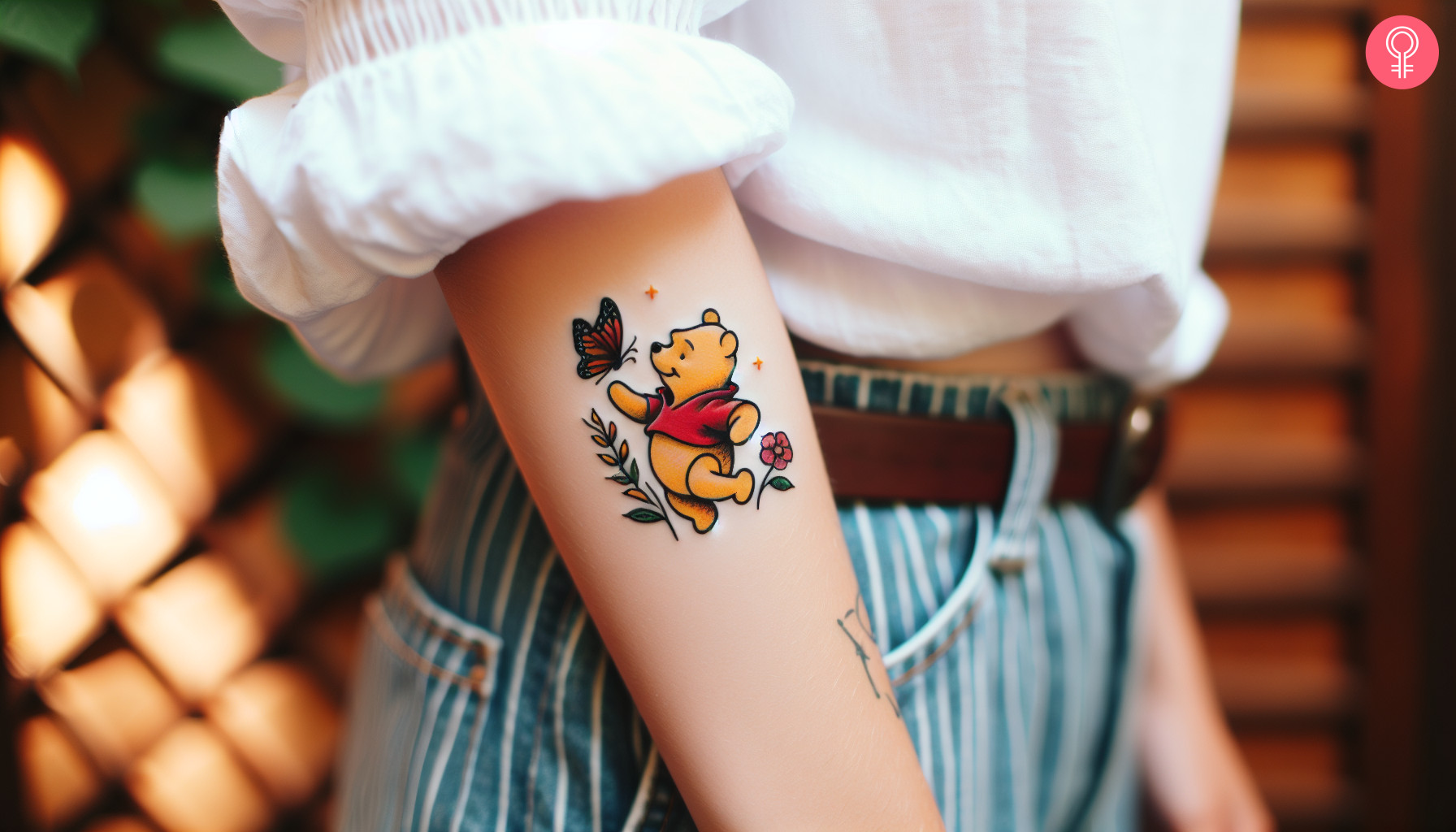 Winnie the Pooh butterfly tattoo on the forearm