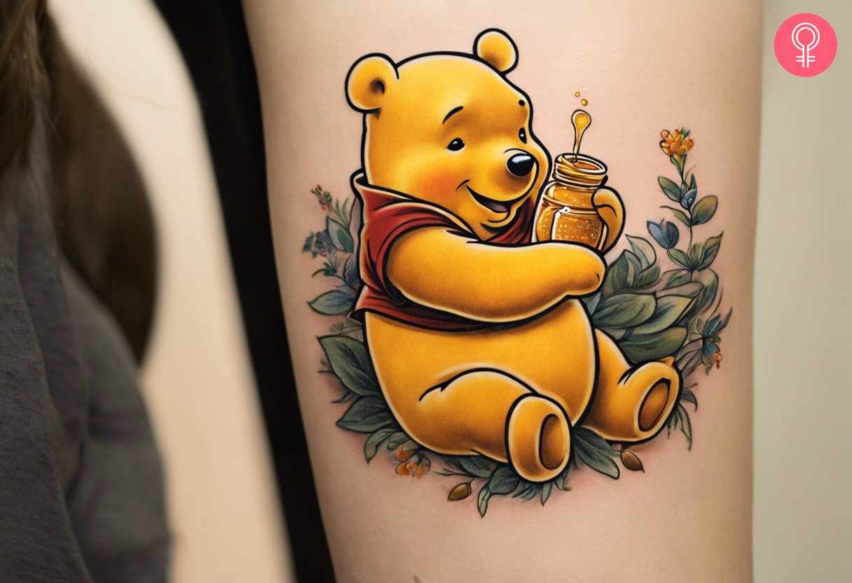 Winnie the pooh honey pot tattoo on the upper arm