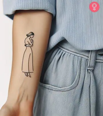 Woman with a pearl tattoo on her arm