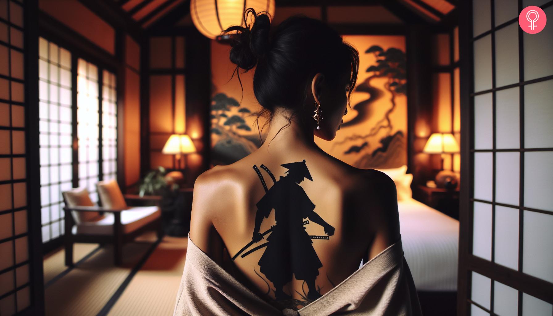 Woman with Ronin silhouette tattoo on her upper back