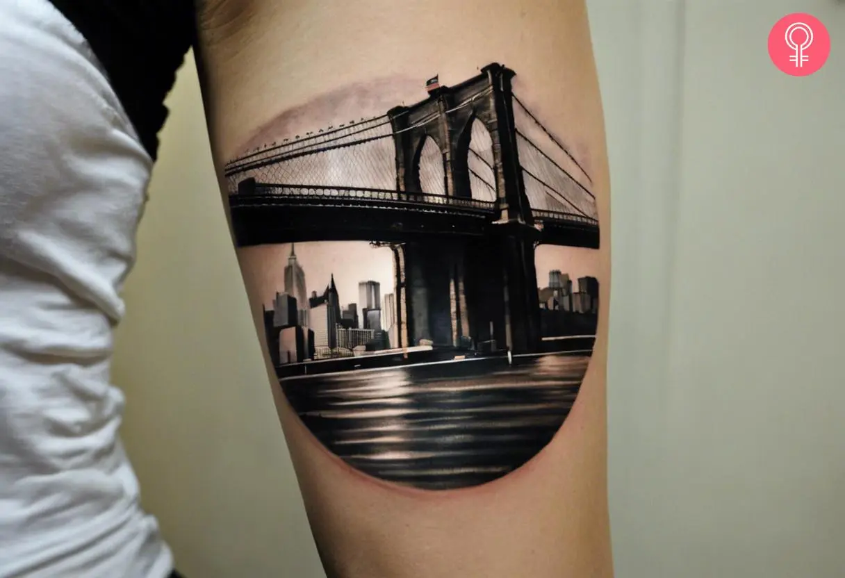 Woman with a Brooklyn bridge tattoo on the arm