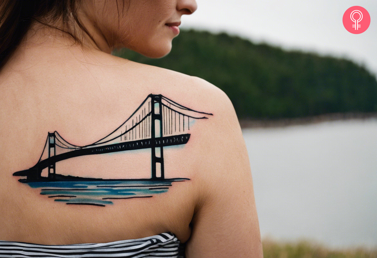 Woman with a Mackinac bridge tattoo on the shoulder