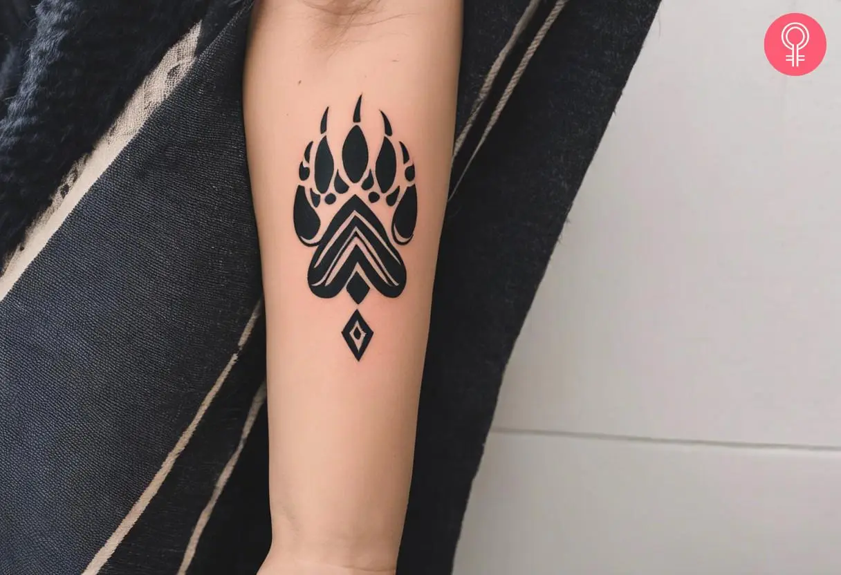 Woman with a Native American bear paw tattoo on her arm