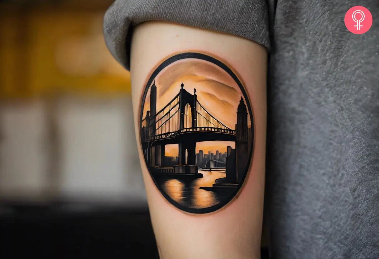 Woman with a Pittsburgh bridge tattoo on the arm