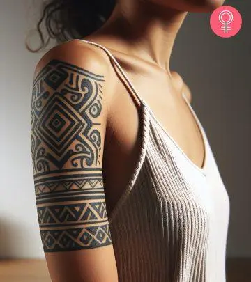 An intricate tattoo on the upper arm of a woman