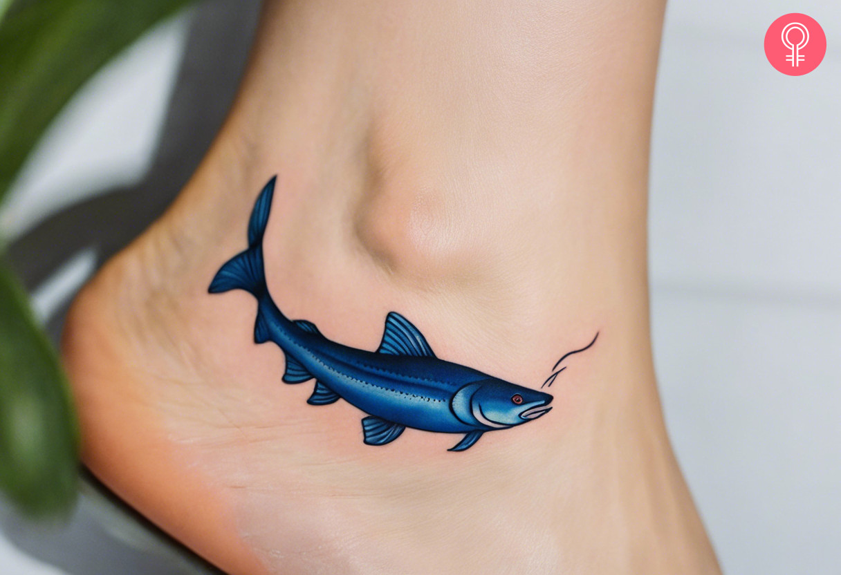 Woman with a blue catfish tattoo on her ankle