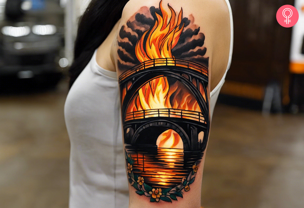 Woman with a burning bridge tattoo on the arm