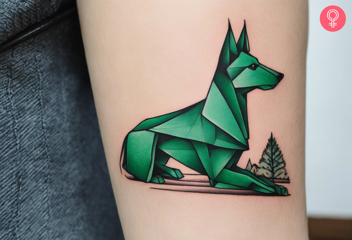 Woman with a green colored origami dog tattoo on the upper arm