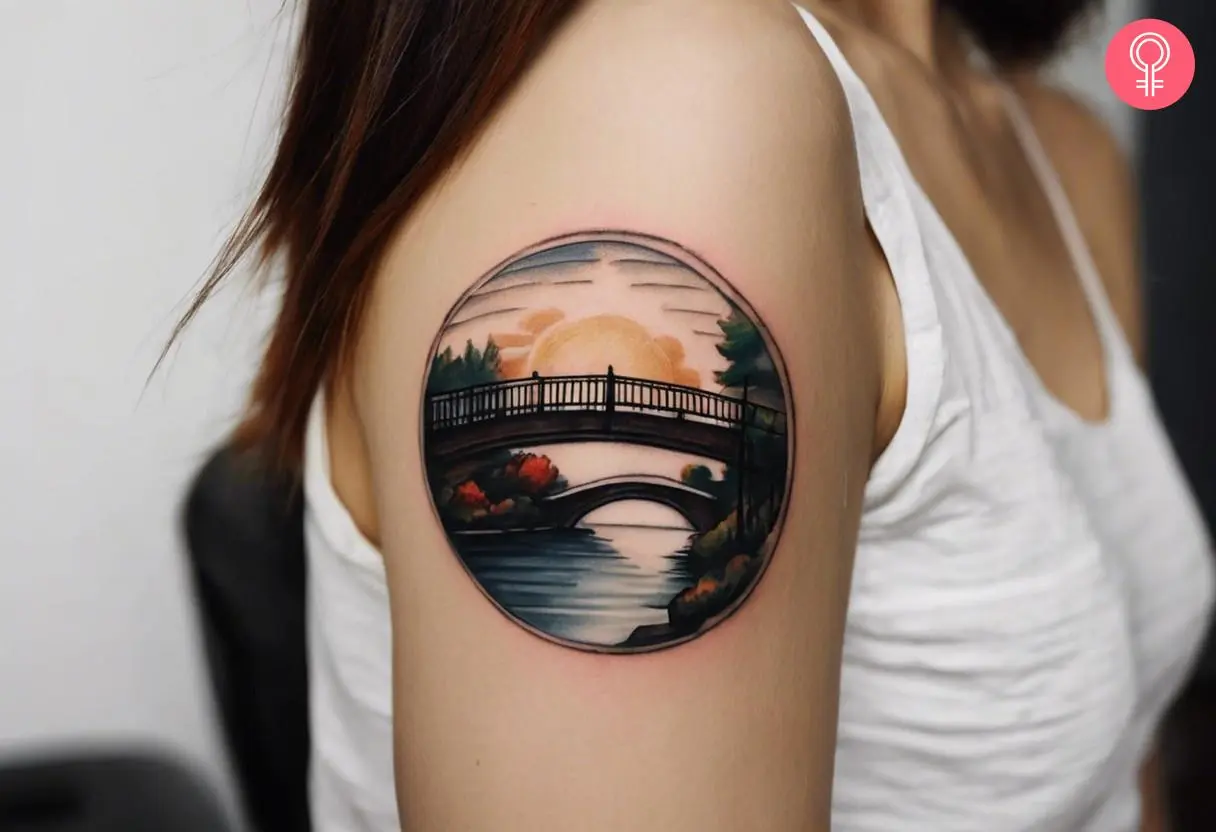 Woman with a small bridge tattoo on the arm