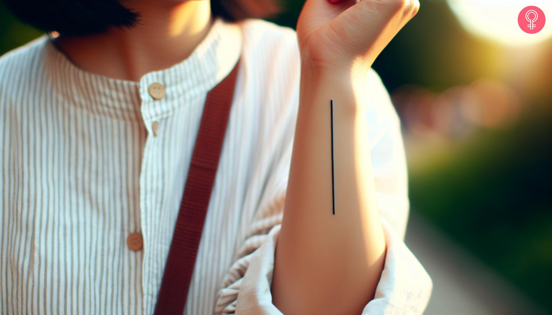 Woman with a straight line forearm tattoo