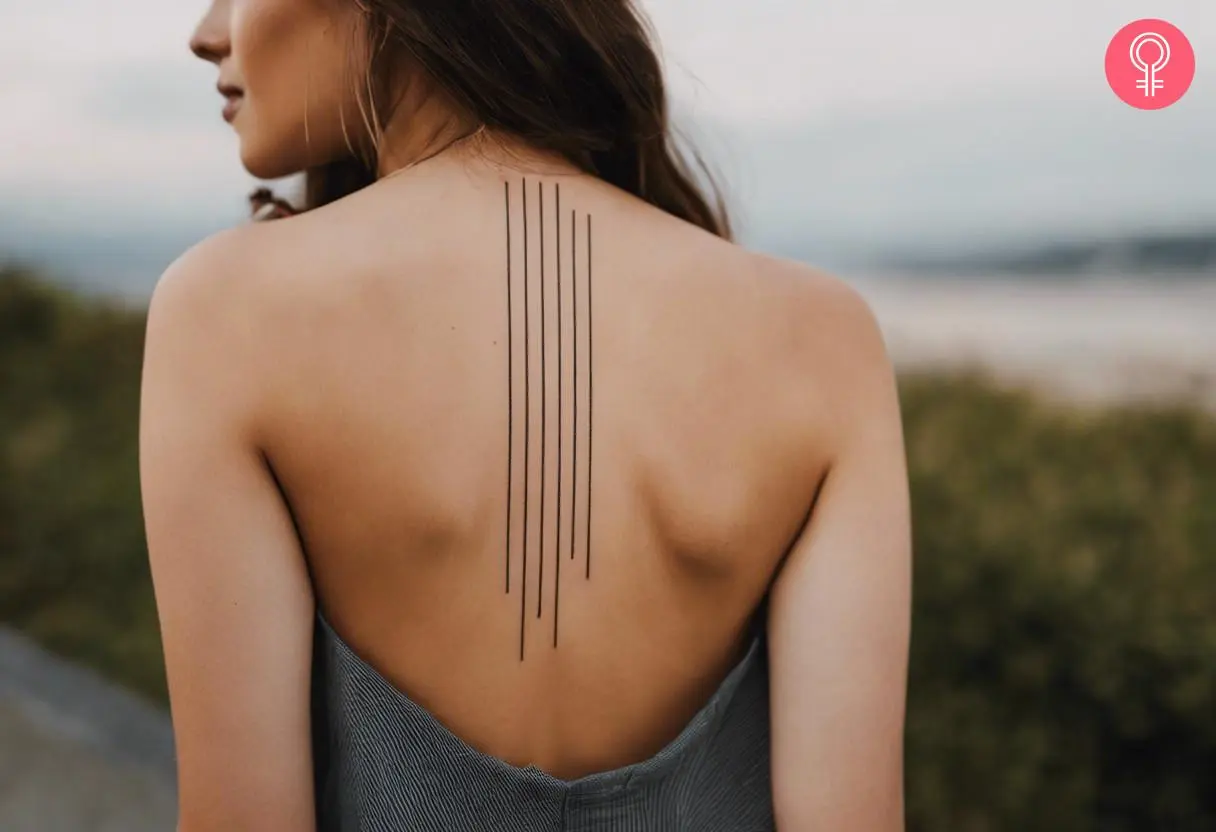 Woman with a straight line tattoo design on the back