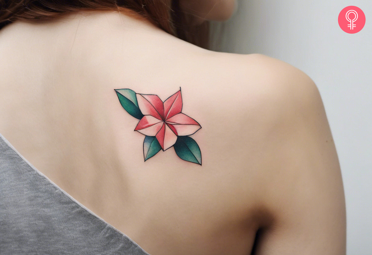 Woman with a sweet little flower origami tattoo on her back