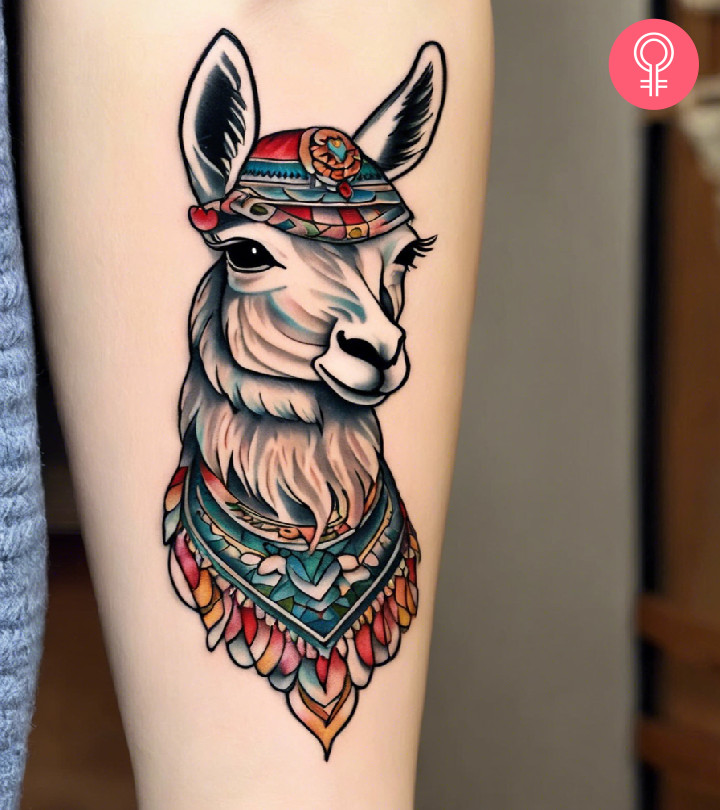 Woman with a traditional llama tattoo with a scarf and a headdress inked on the forearm