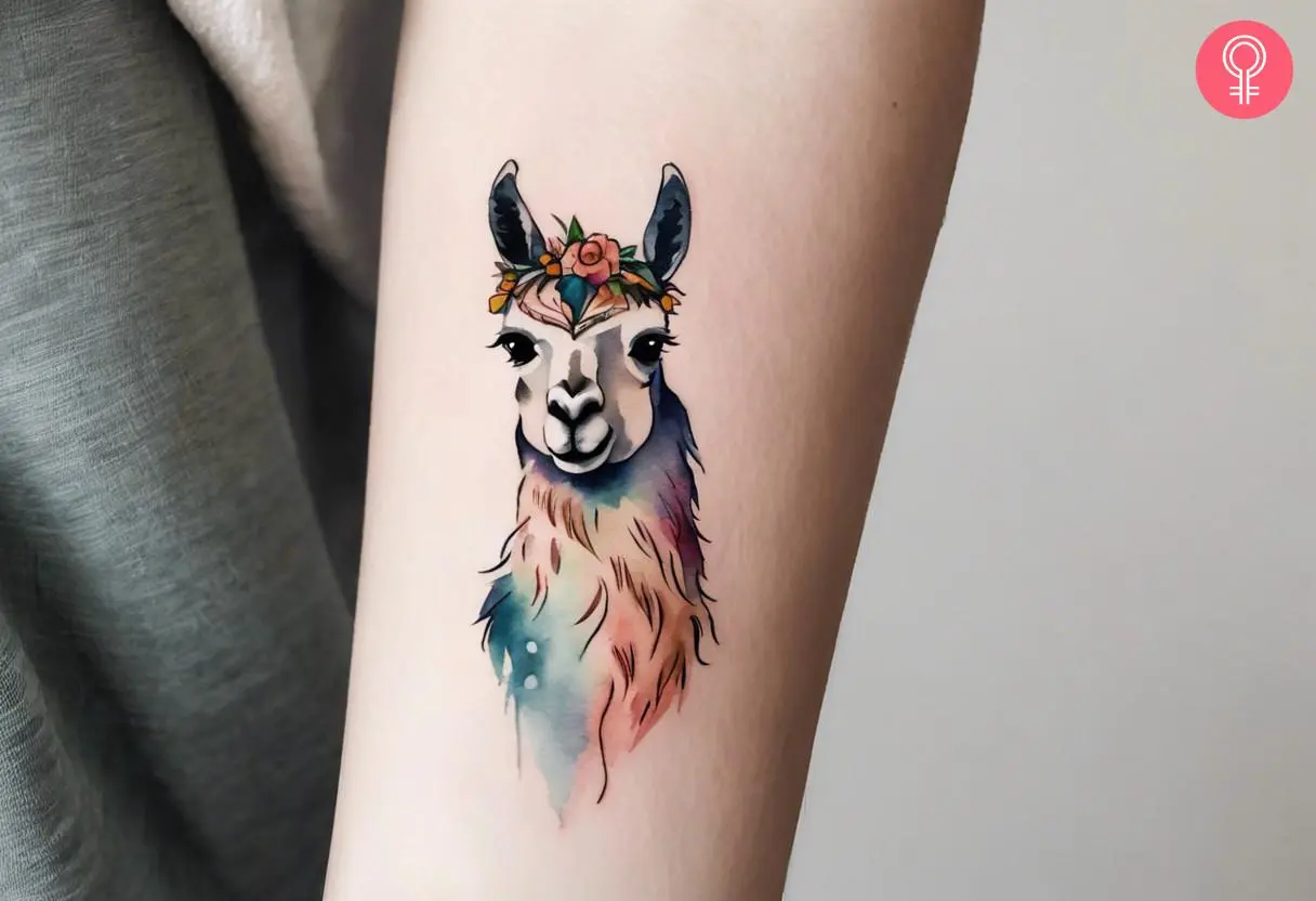 Woman with a watercolor llama head inked on the forearm