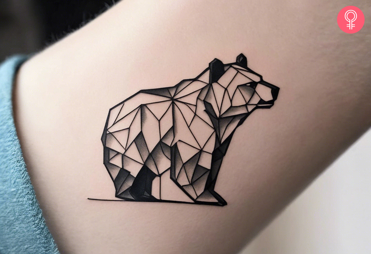Woman with an origami bear tattoo on the forearm