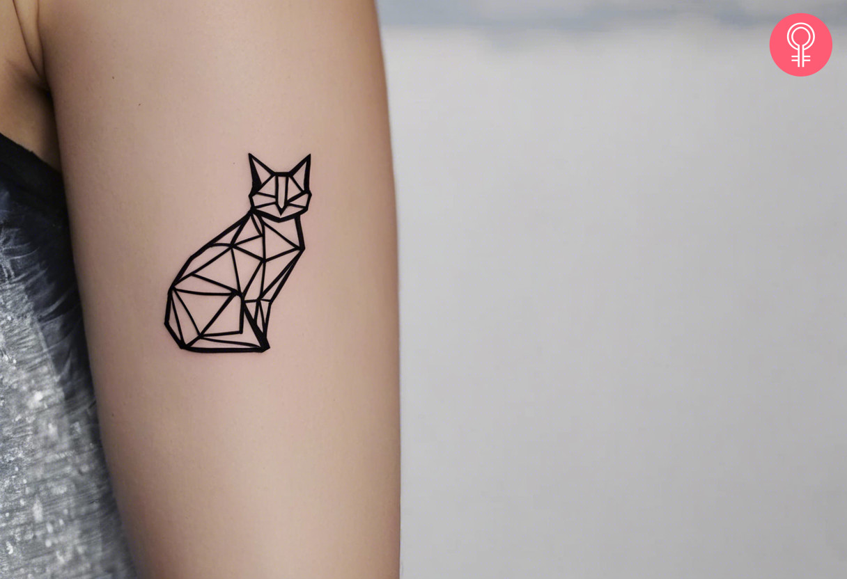 Woman with an origami cat tattoo on the upper arm