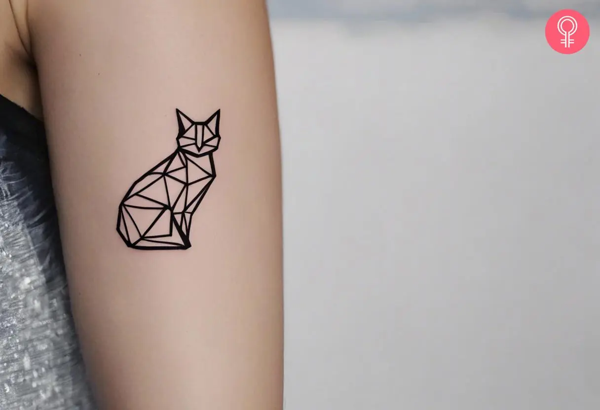 Woman with an origami cat tattoo on the upper arm