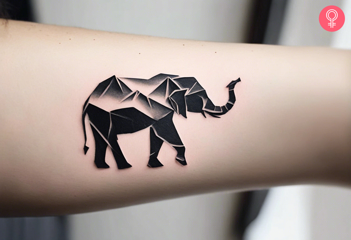 Woman with an origami elephant tattoo on the upper arm