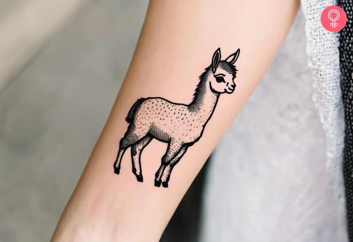 Woman with an outline baby llama inked on the forearm