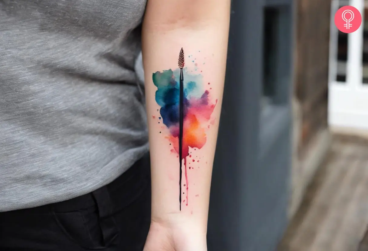 Woman with artistic paintbrush tattoo on her forearm