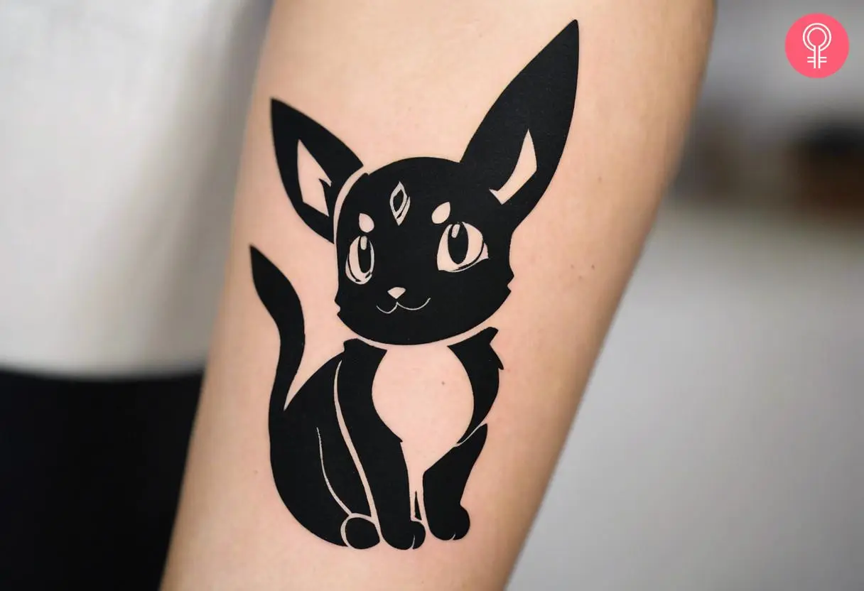 Woman with black-and-white Umbreon tattoo on her forearm