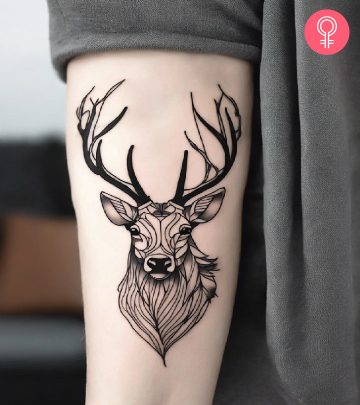 Ox tattoo on the upper arm of a woman