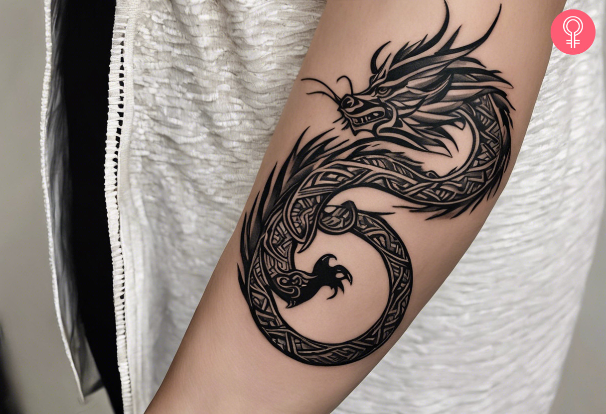 Woman with forearm tribal dragon tattoo