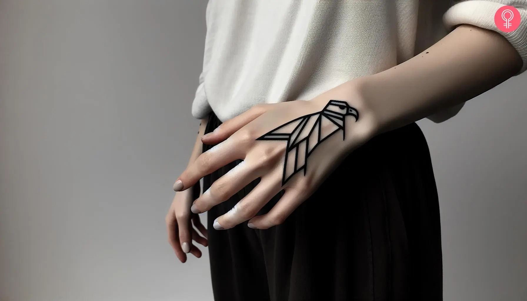 Woman with geometric condor tattoo on the back of her hand