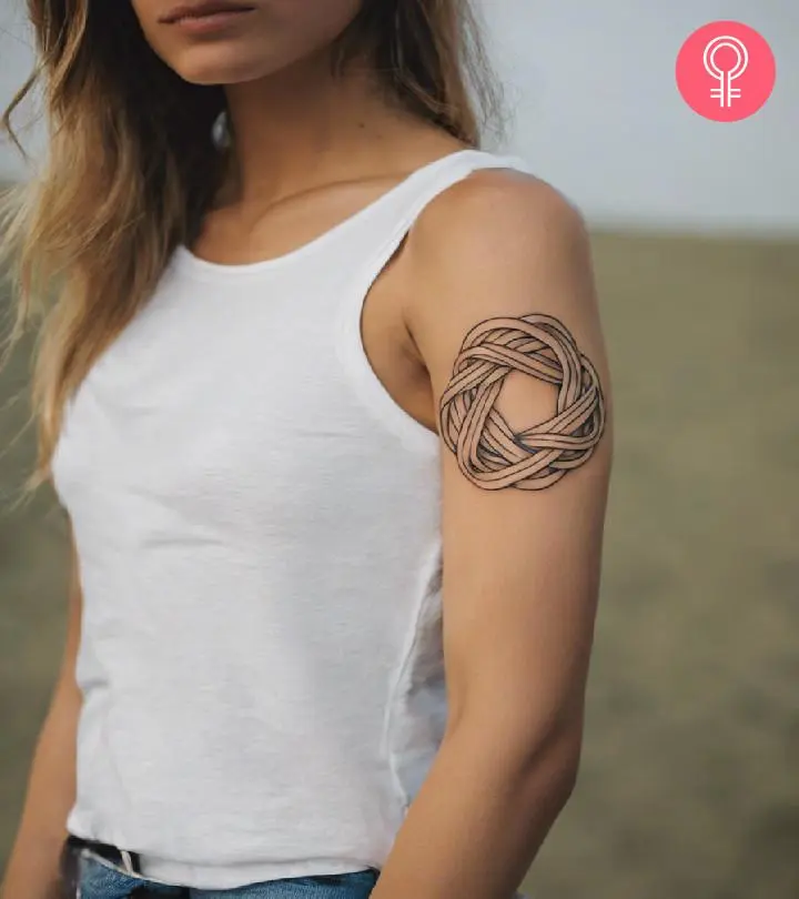 Woman with knot tattoo on her upper arm