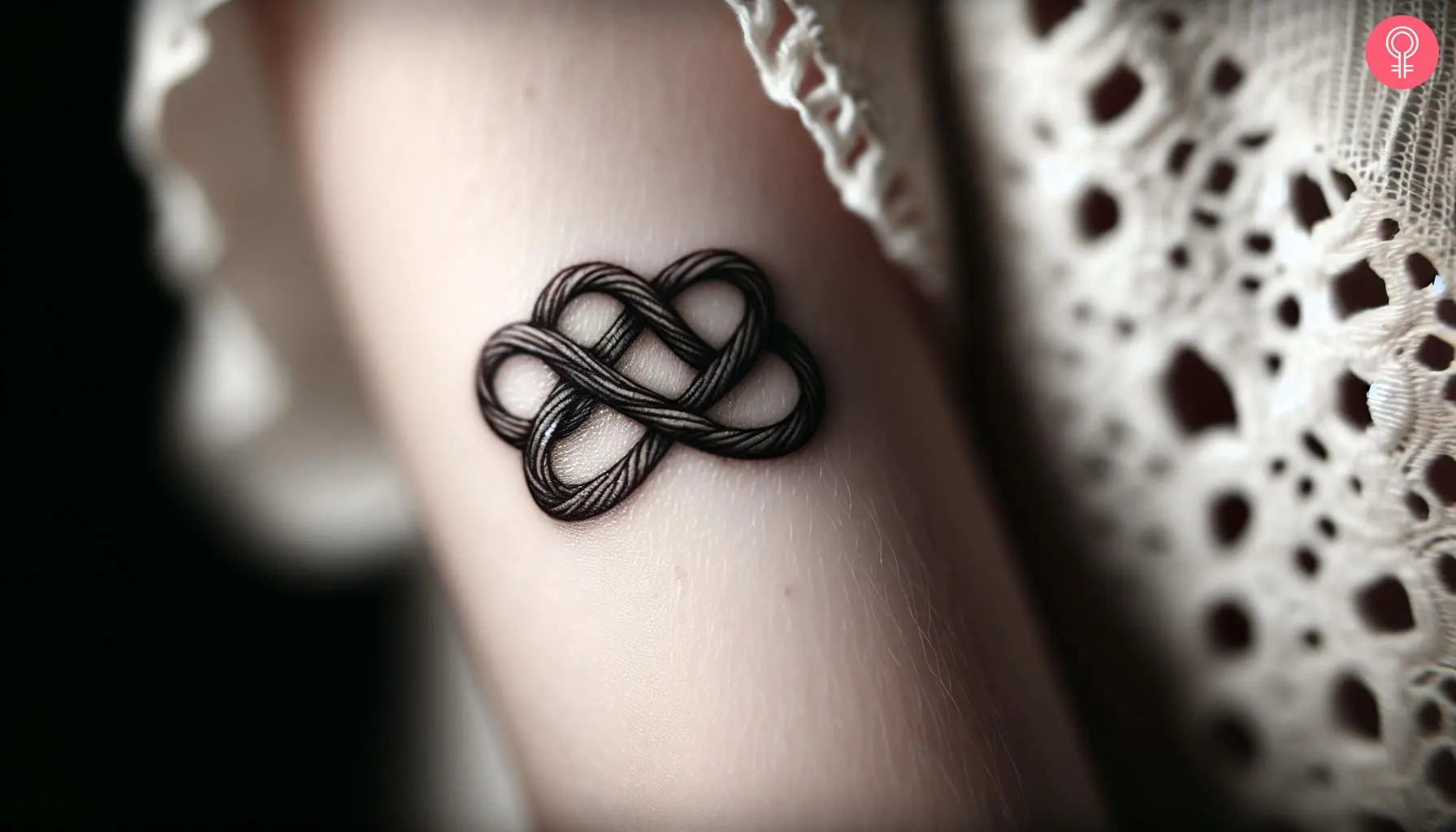 Woman with love knot tattoo on her forearm