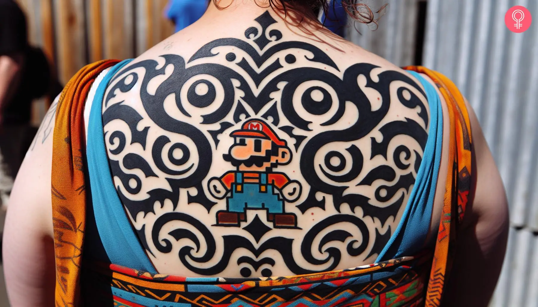 Woman with mario tribal tattoo on her upper back