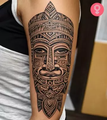 A woman with an island tattoo on her arm