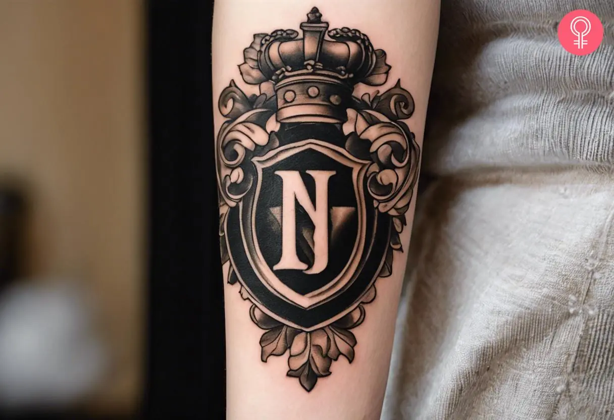 Woman with realistic family crest tattoo on her forearm